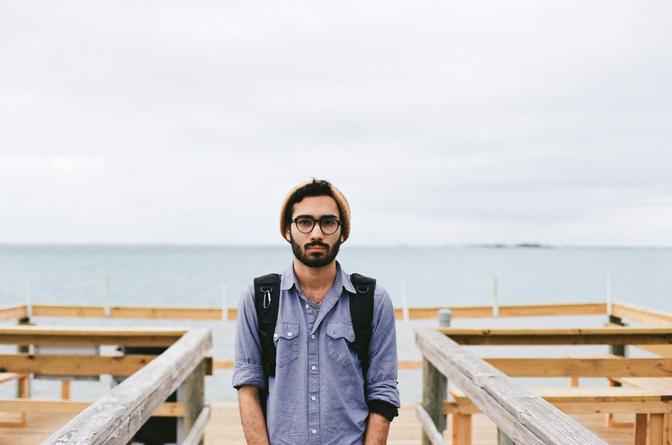 My friend Juan standing in front of the beach